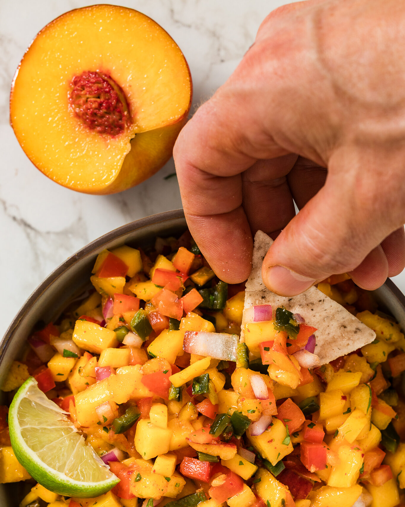 Peach Mang Salsa in a Bowl with a Chip