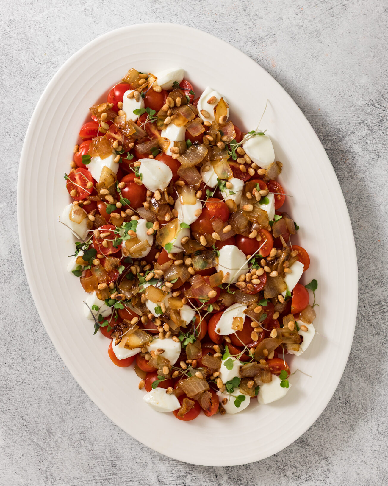 cherry tomatoes, mozzarella, micro greens and pine nuts